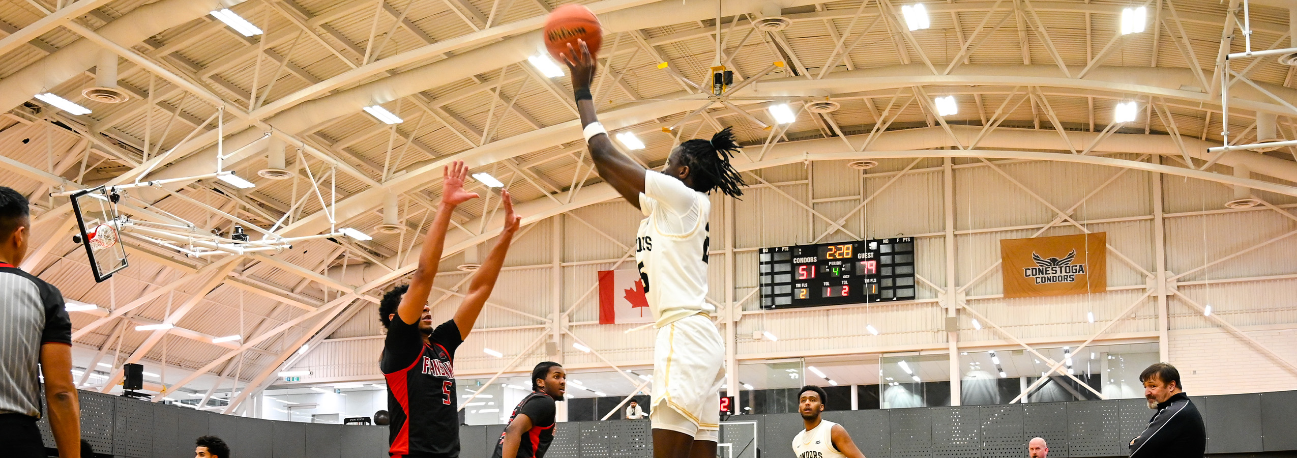 A photo banner of a Conestoga Condor men's basketball player shooting a basketball. 