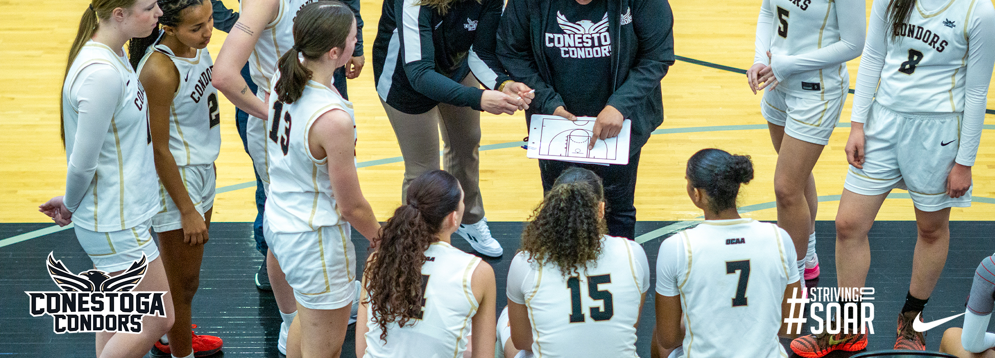 A photo banner showing the women's basketball team huddling up. 